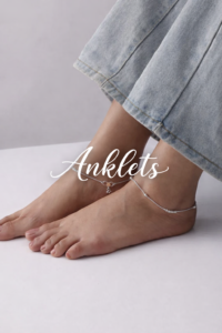 Elegant silver anklets on cropped jeans